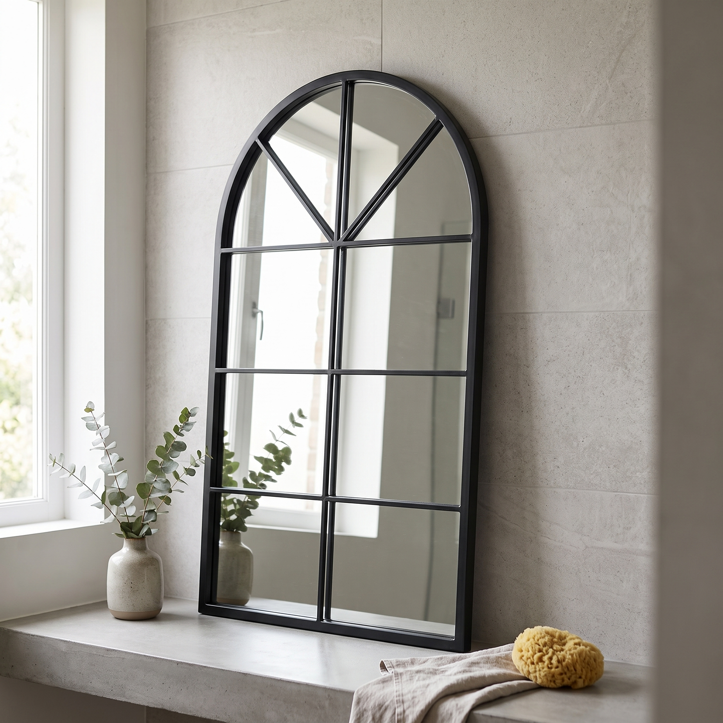 Dewfig arched windowpane wall mirror in a contemporary bathroom