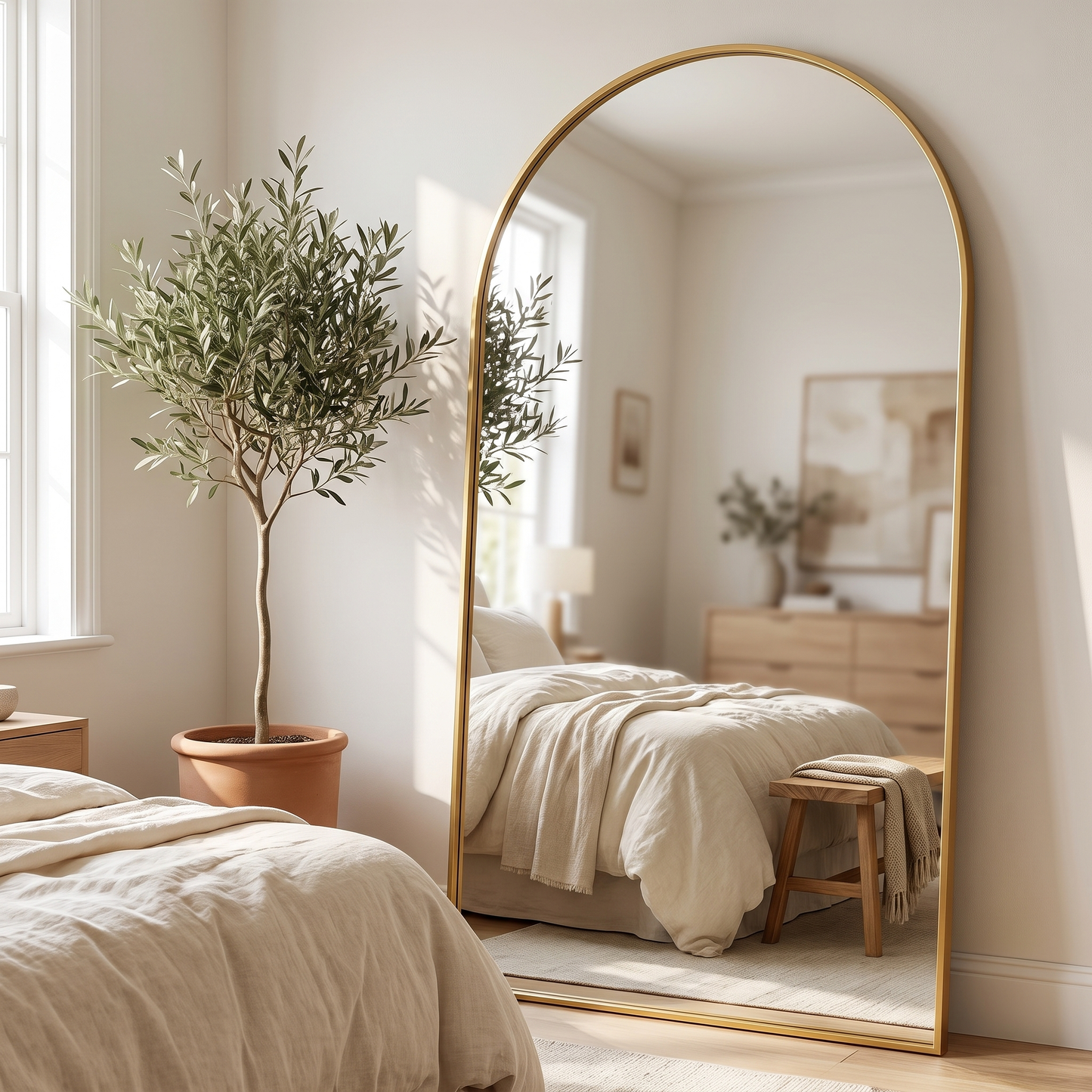 Gold metal arched full-length mirror, wider bedroom view