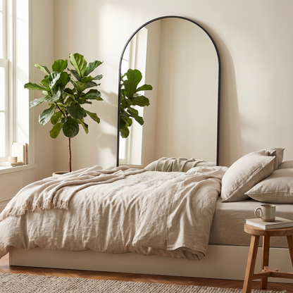 Silver arched stand full-length mirror in a styled bedroom