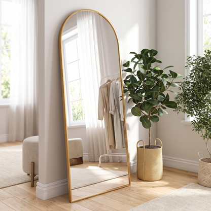 Gold metal arched bracket full-length mirror in a dressing room
