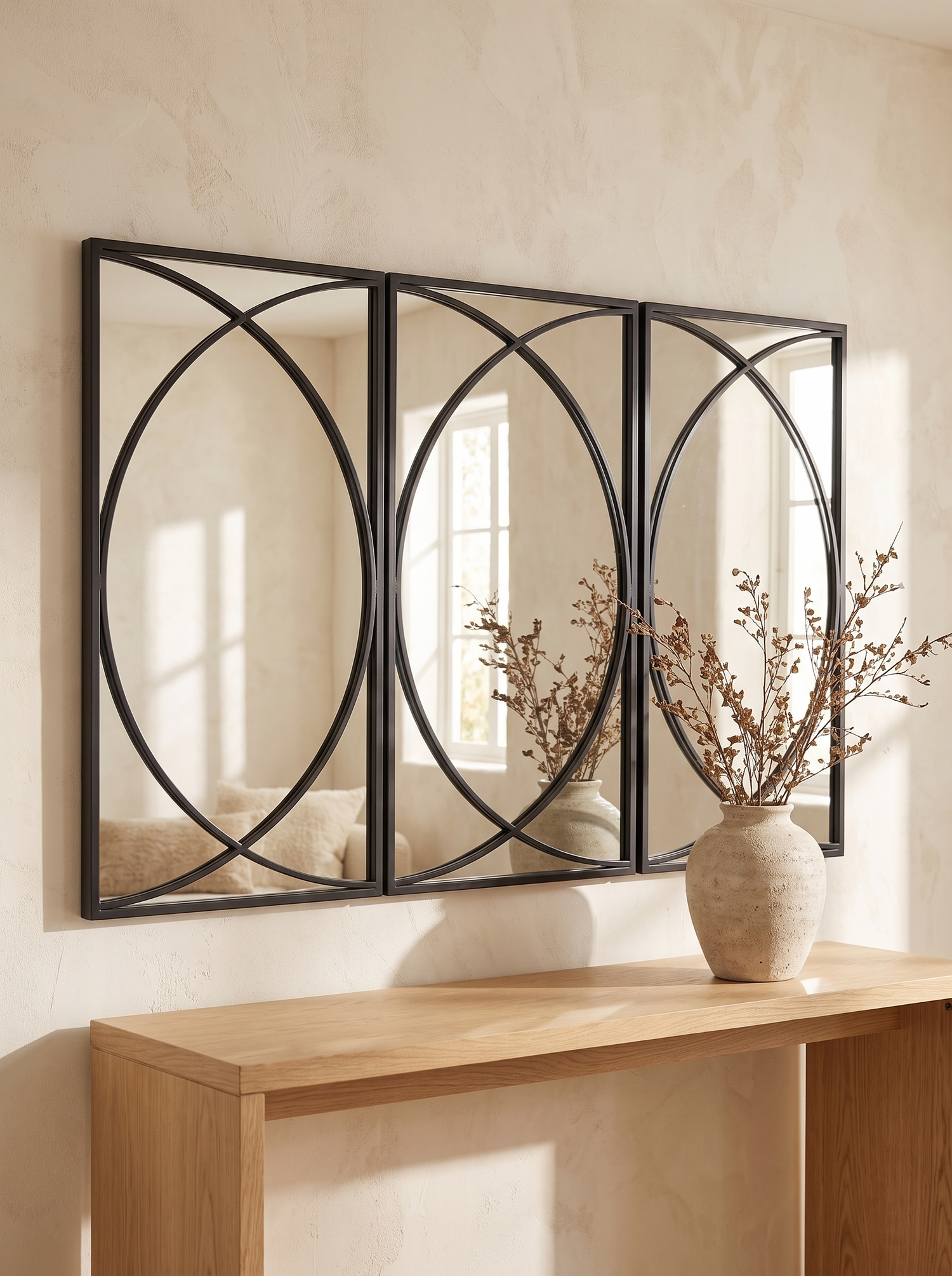 LuxAura Arc Trio mirror set hung as one arc above a light oak console
