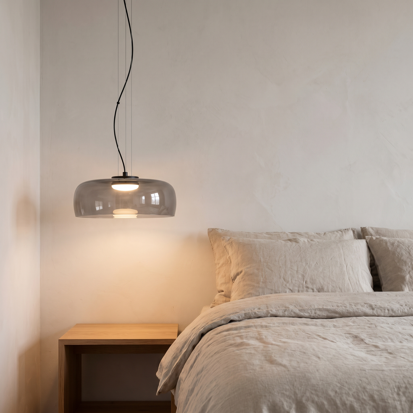 Nordic Glass Pendant Light in grey beside a minimalist bedside table