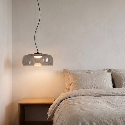 Nordic Glass Pendant Light in grey beside a minimalist bedside table