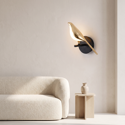 Metal bird shape LED wall sconce beside a living room sofa