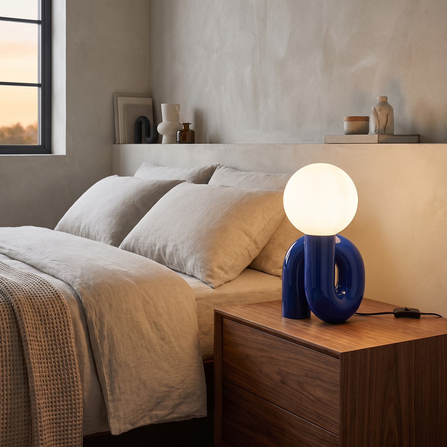 Resin table lamp in blue on a bedroom nightstand