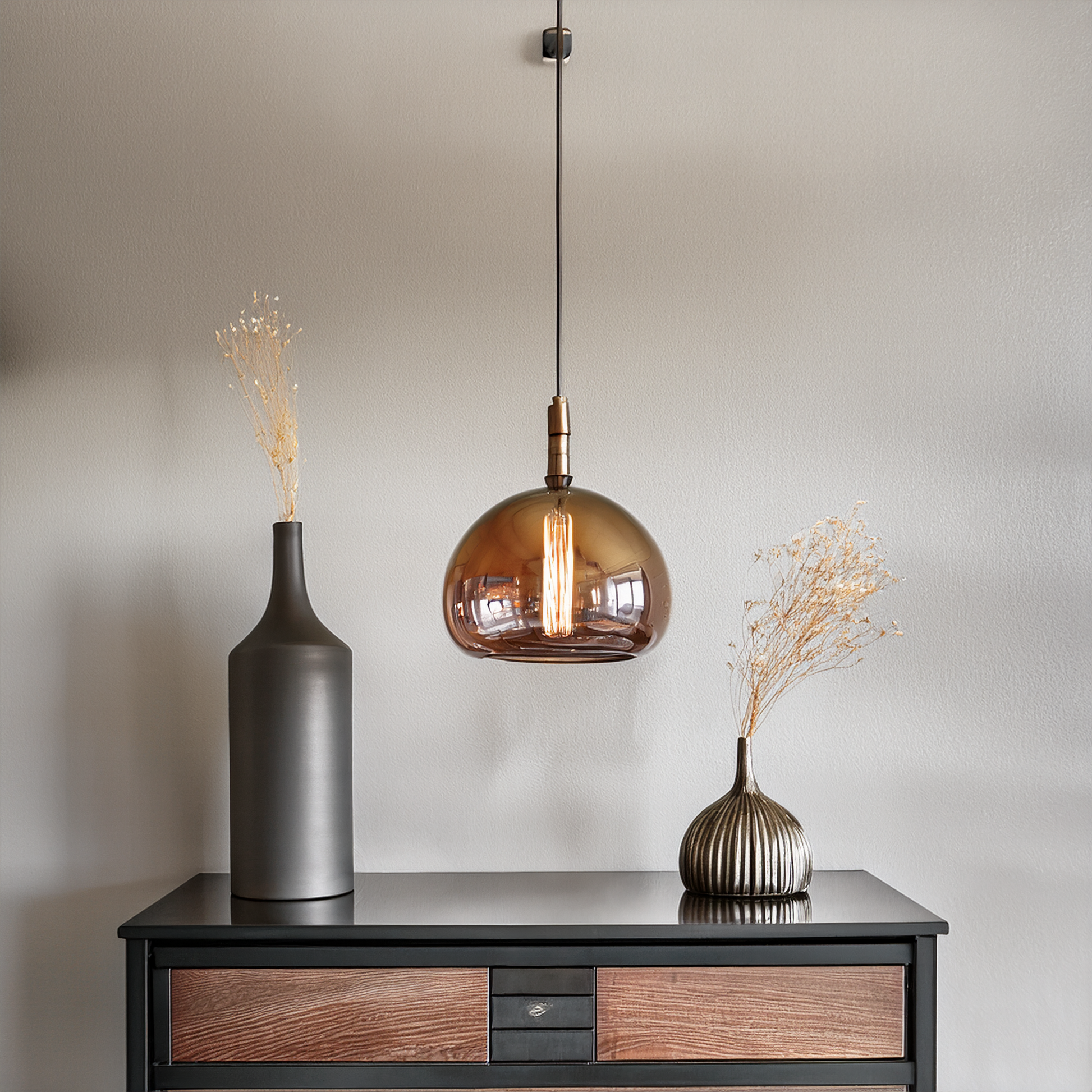Glass pendant light above an entryway console table
