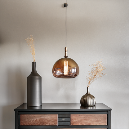 Glass pendant light above an entryway console table