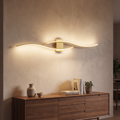 Gold LED wave wall sconce with warm light in a living room