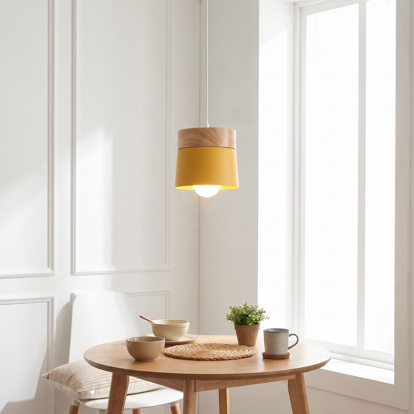 Yellow solid wood pendant light above a breakfast nook
