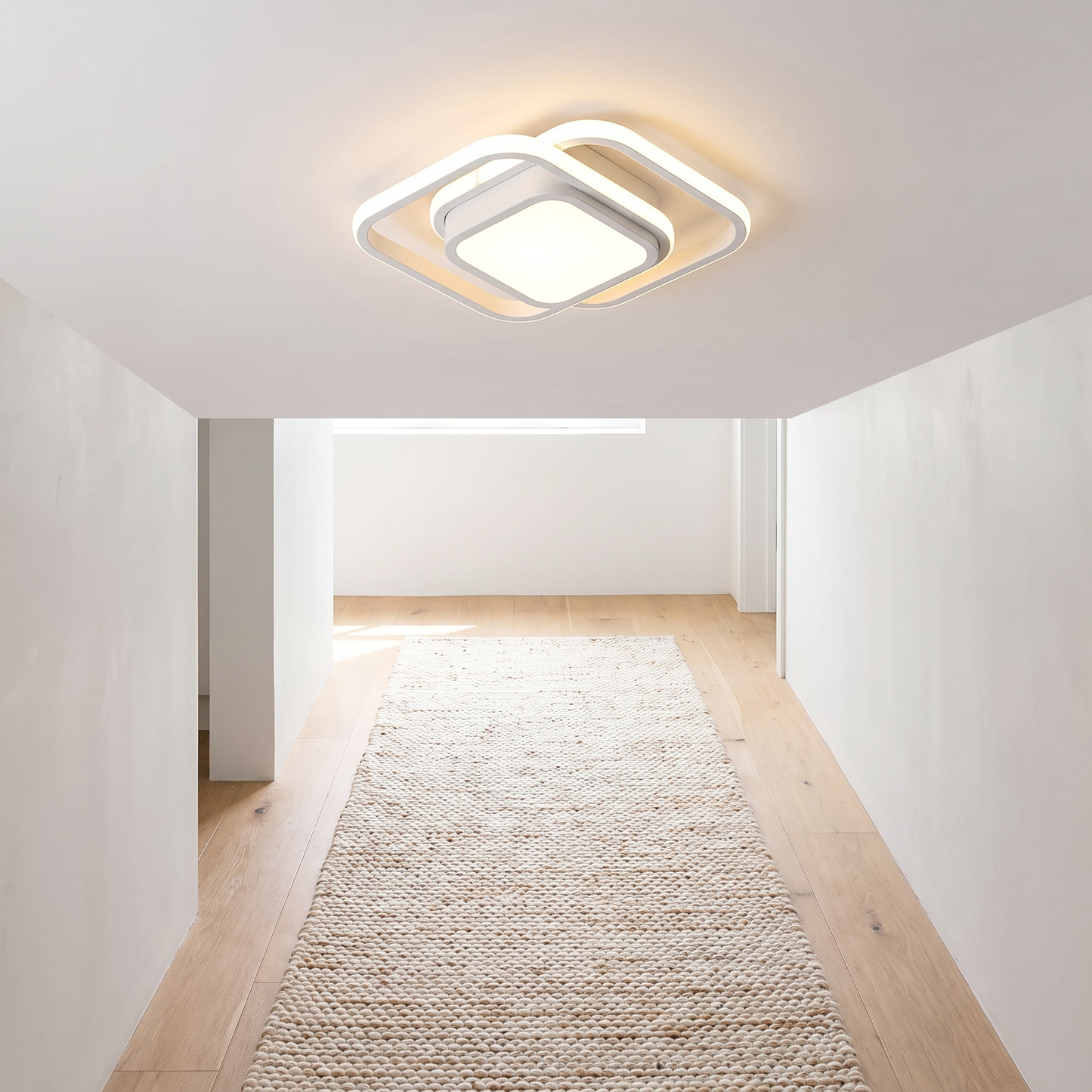 Square all white minimalist ceiling light in a bright hallway