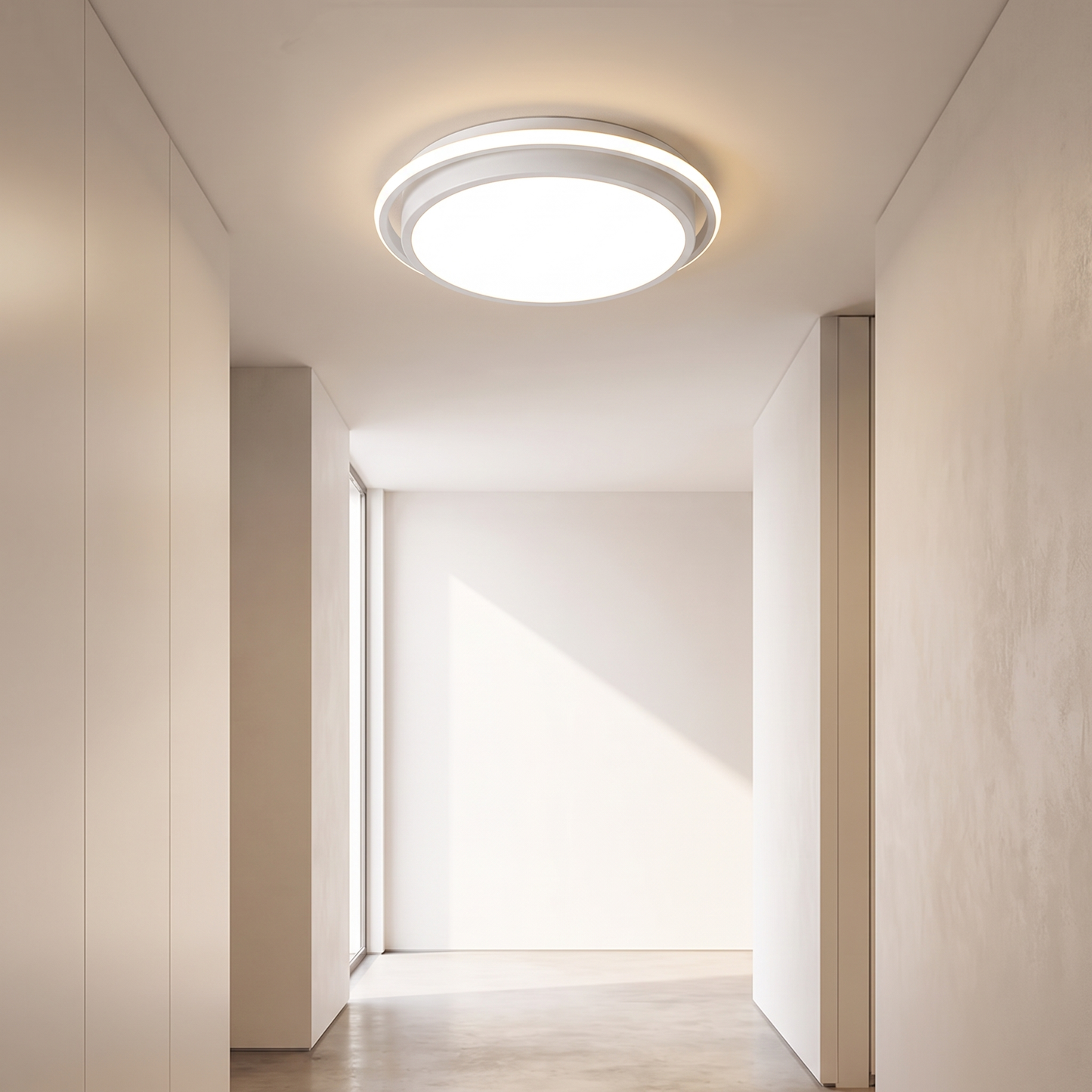Round all white minimalist ceiling light in an apartment corridor