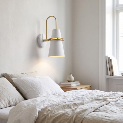 White Nordic wall sconce beside a bed
