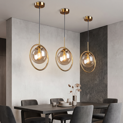 Smoke grey glass pendant light in a dining nook