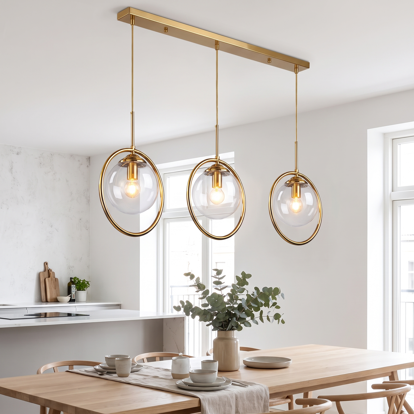 Clear glass pendant lights in a row above a dining table