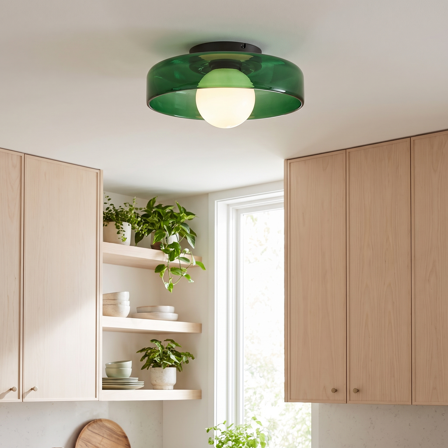 Green glass ceiling light in a bright kitchen