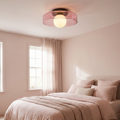 Pink glass ceiling light in a blush-toned bedroom