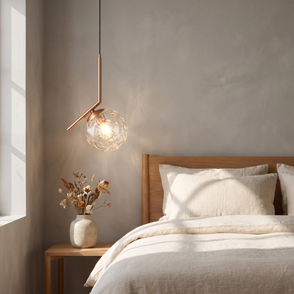 Copper gold glass-section bedroom pendant light beside a bed