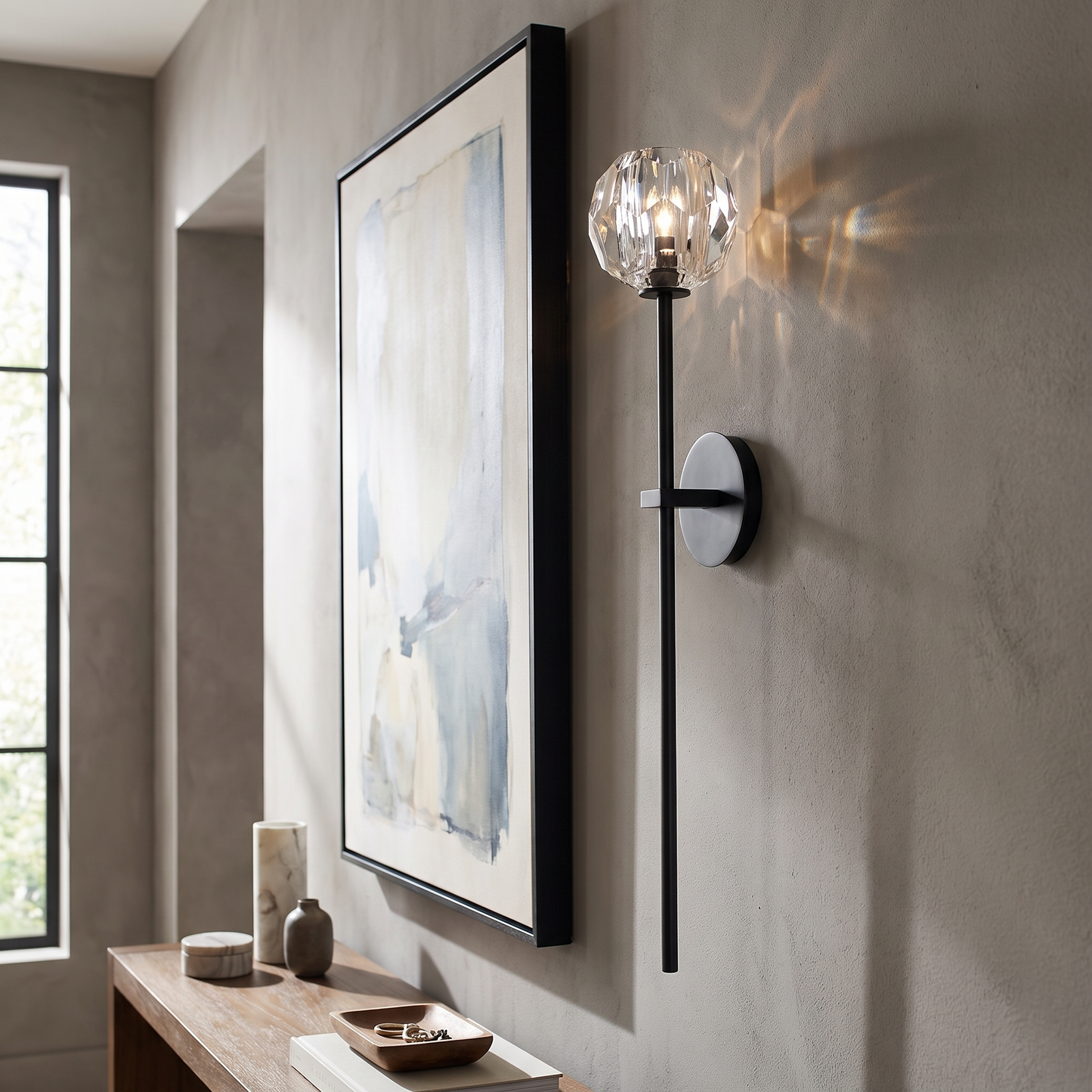 Balle crystal wall sconce in a hallway beside artwork