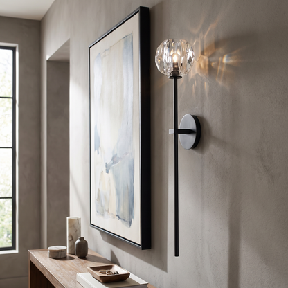 Balle crystal wall sconce in a hallway beside artwork