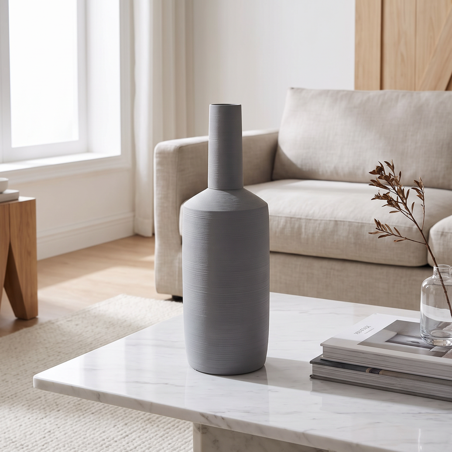 Neutral grey ceramic vase on a marble coffee table