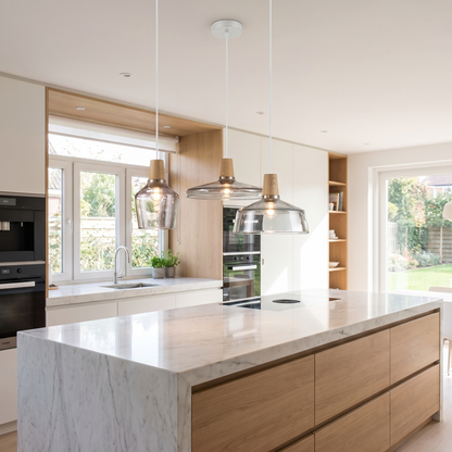 Three-head glass pendant light above a kitchen island