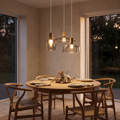 Three-head glass pendant light above a dining table
