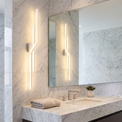Linear LED wall sconce beside a bathroom mirror