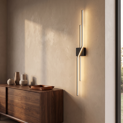 Black minimalist linear LED wall sconce in a living room