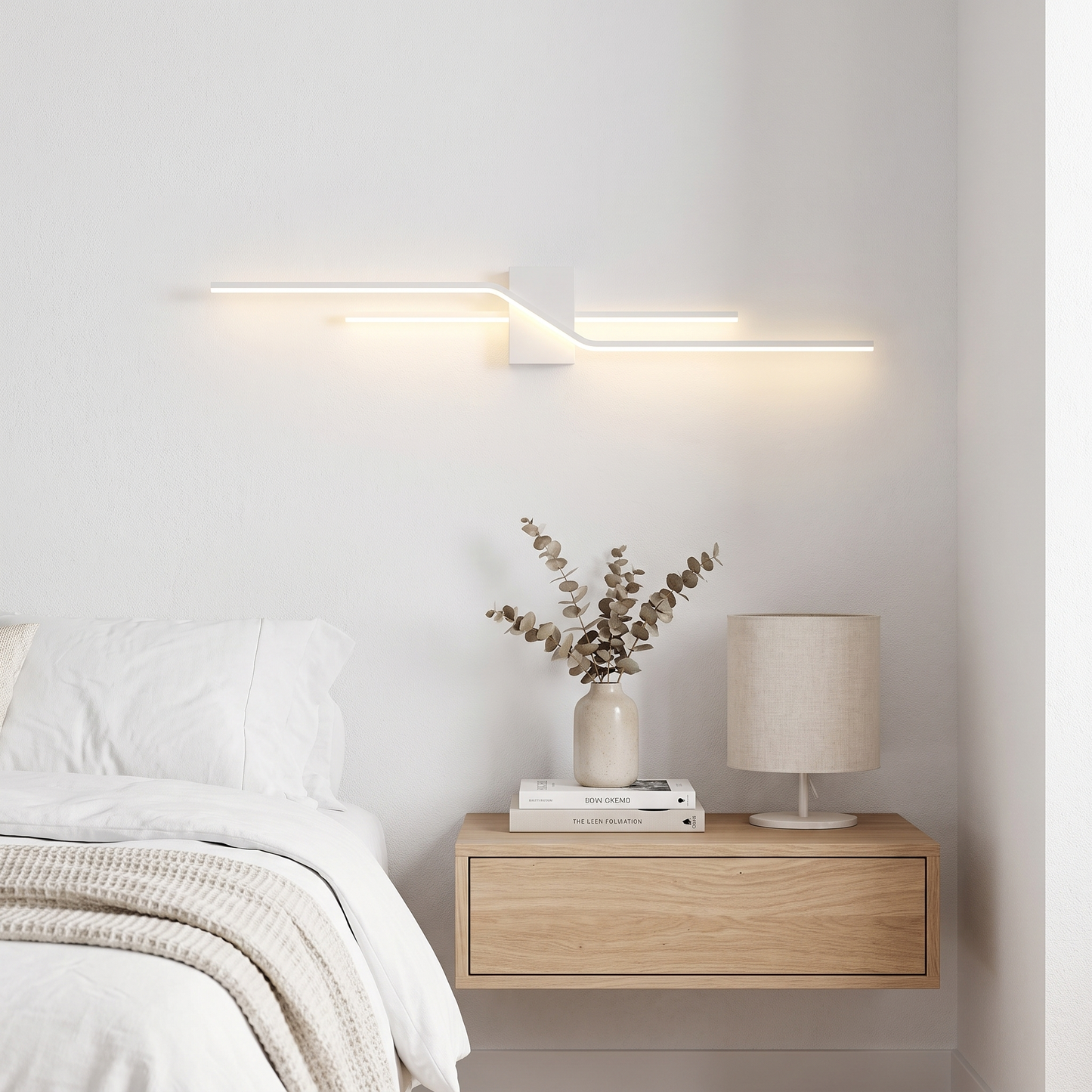 White minimalist linear LED wall sconce in a bedroom