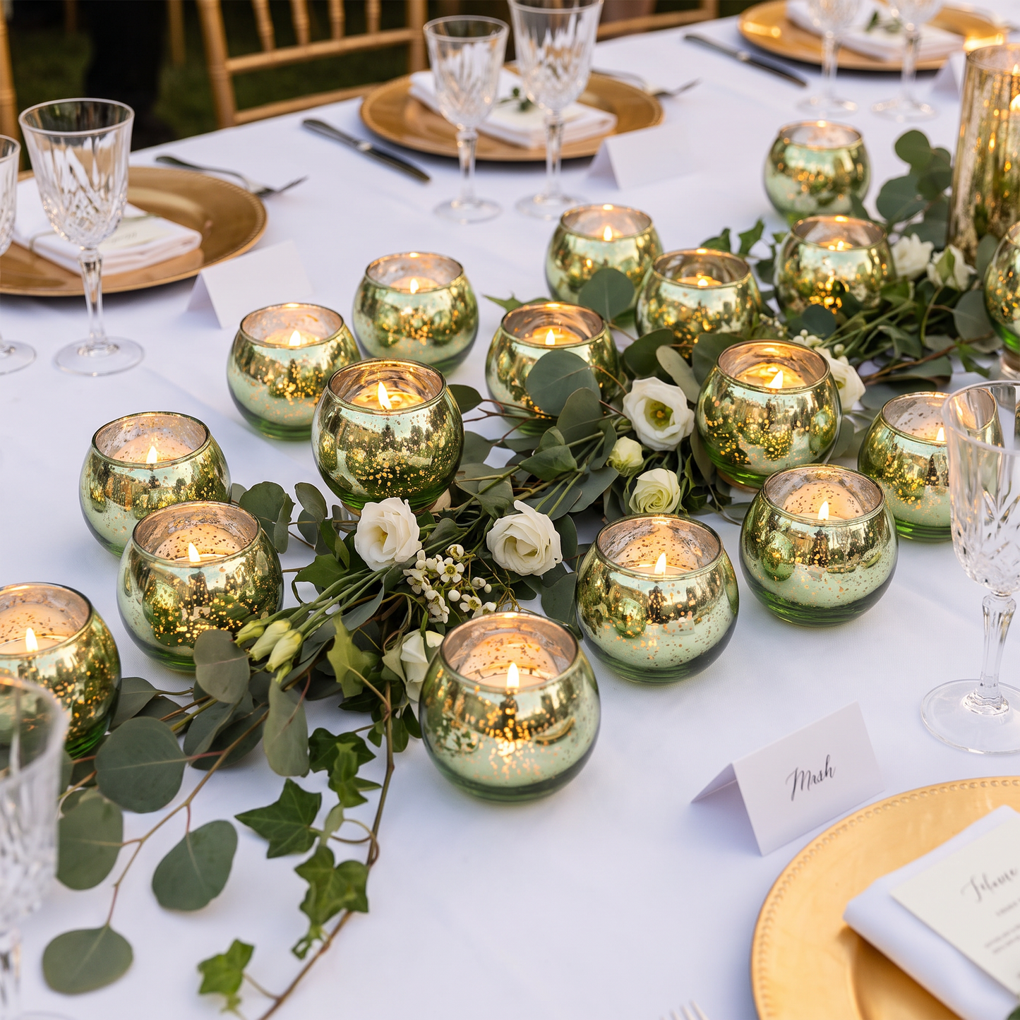 Green mercury glass votive holders as a wedding centrepiece