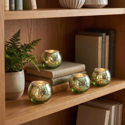 Green mercury glass votive holders styled on a bookshelf