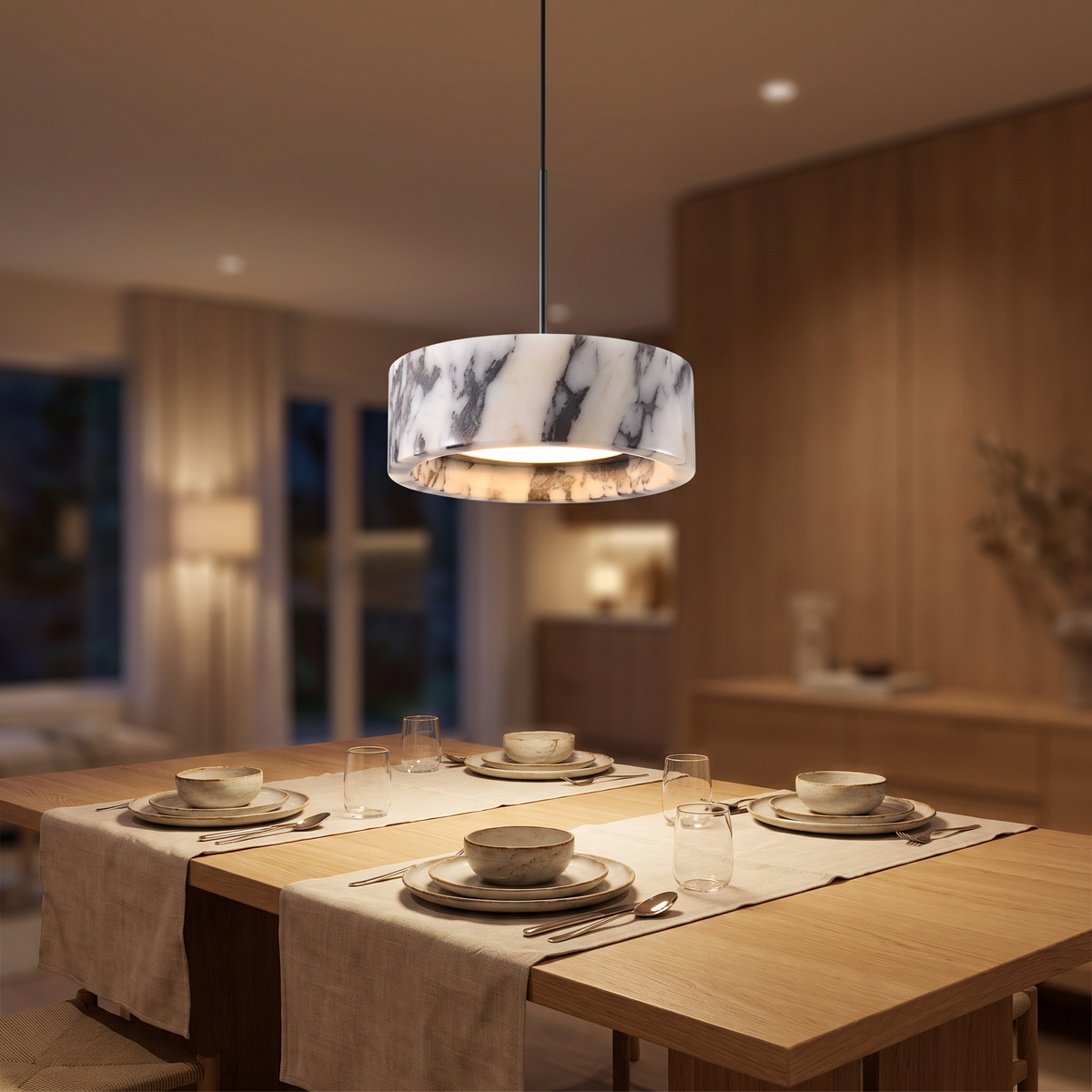 Marble drum pendant light above a modern dining table