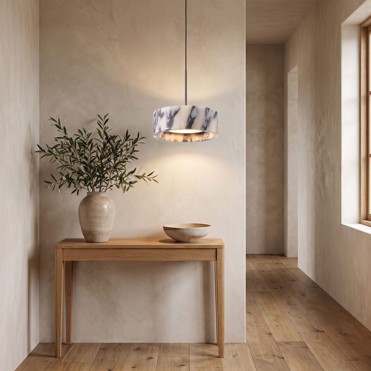 Marble drum pendant light above an entryway console table