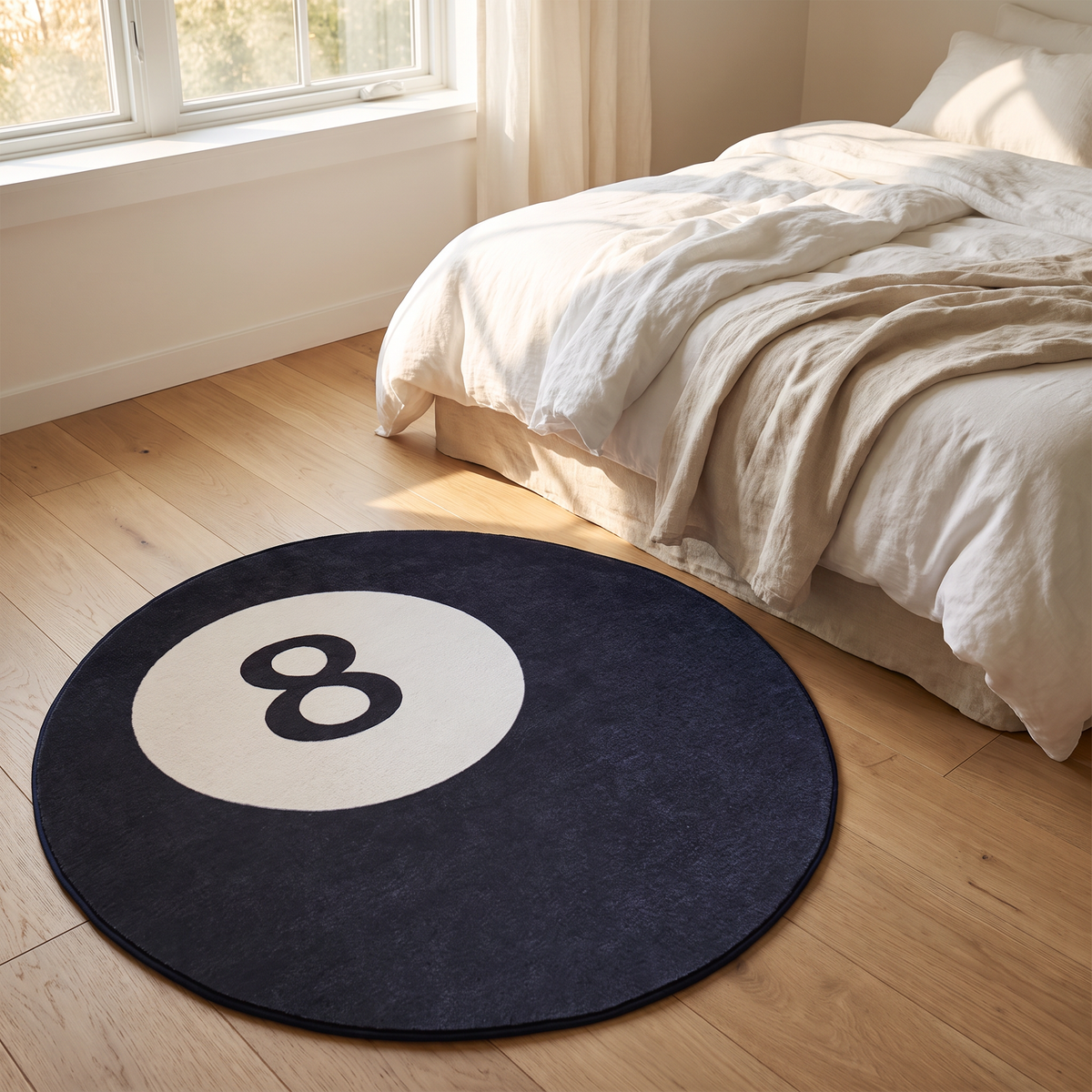 Round faux cashmere rug beside a bed