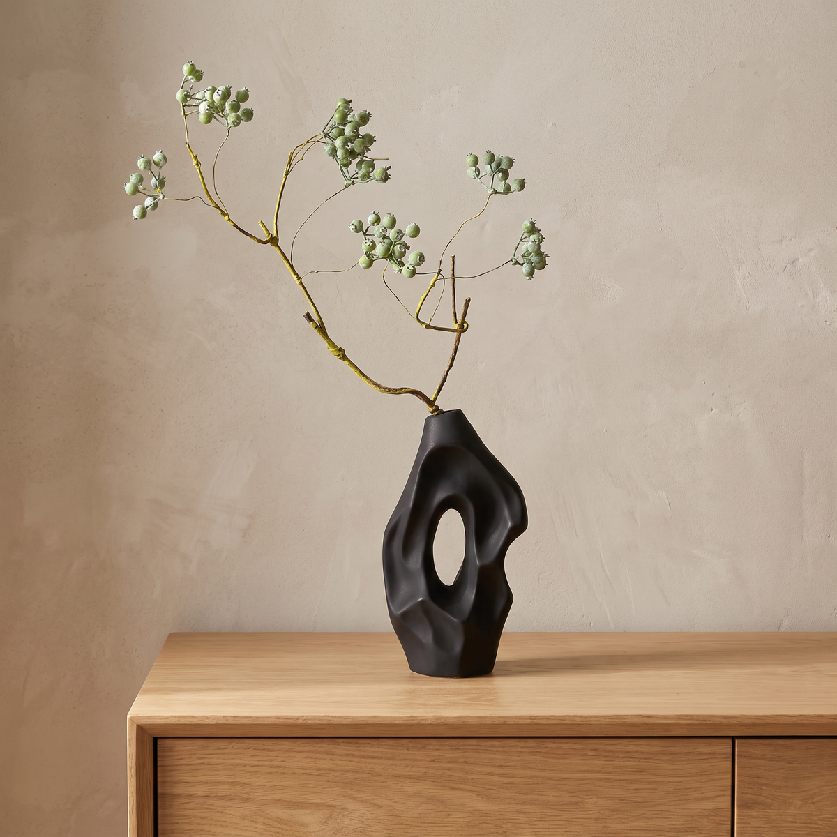 Black vase with artificial mistletoe