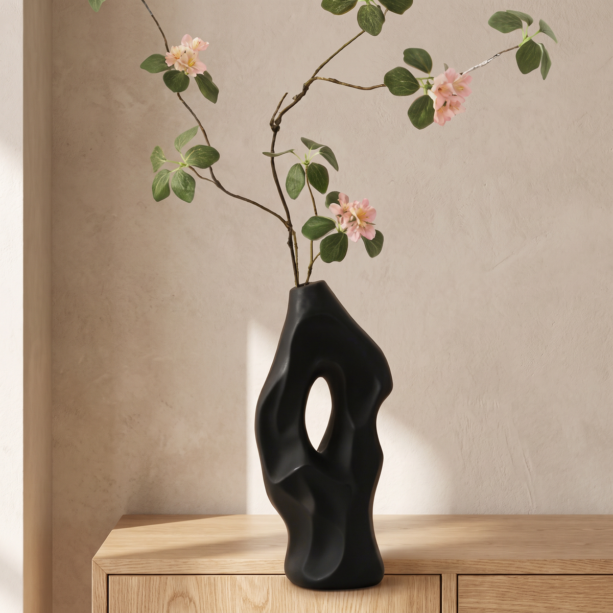 Black vase with artificial sensitive plant