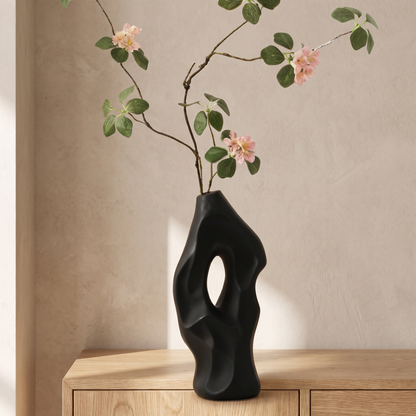 Black vase with artificial sensitive plant