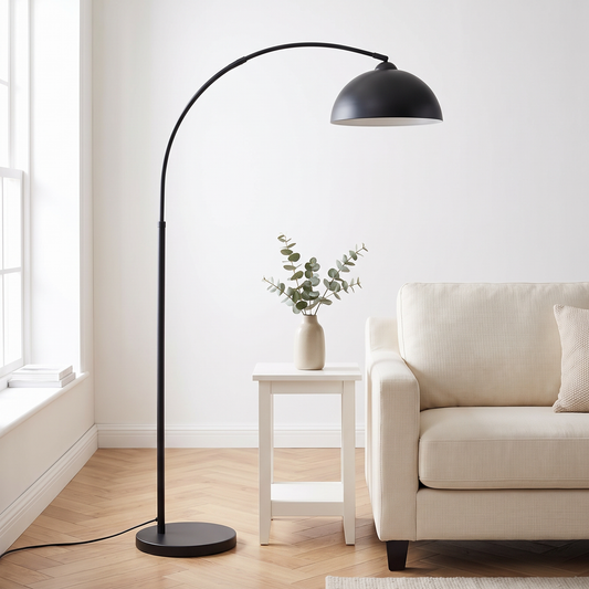 Scandinavian arc LED floor lamp in black over a cream sofa