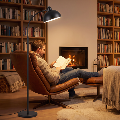Scandinavian arc floor lamp lighting a reading chair