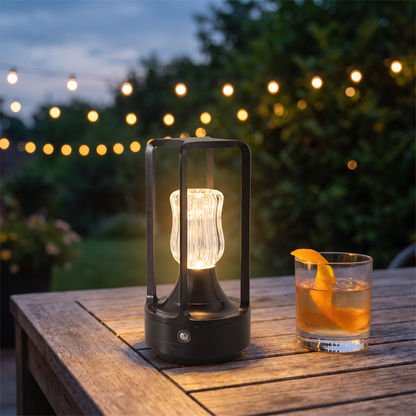 Black cordless table lamp on a patio table at twilight