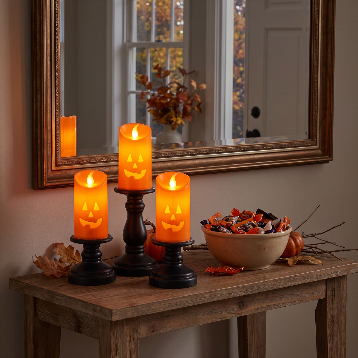 Pumpkin candlesticks on an entryway console