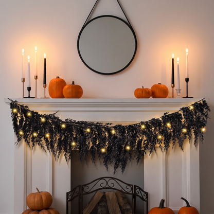 Black pine garland with lights on a fireplace mantel