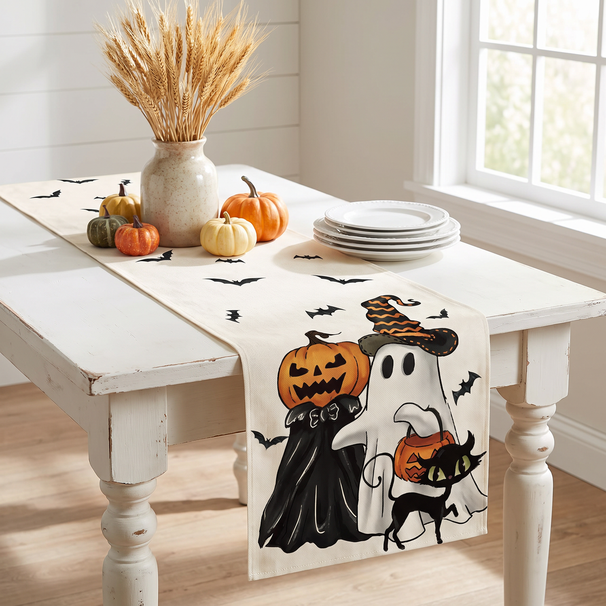 Pumpkin and ghost Halloween table runner on a farmhouse kitchen table