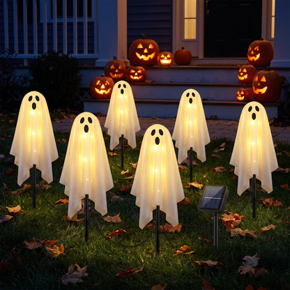 Six warm-glow solar ghost lights on a front lawn at night