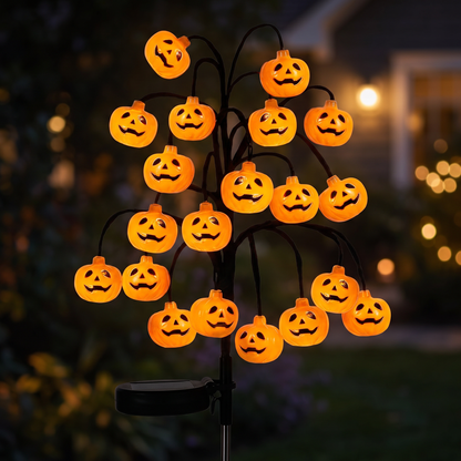 Close-up of glowing jack-o-lantern bulbs on the branch light