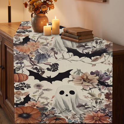 Floral ghost Halloween table runner on a wooden sideboard