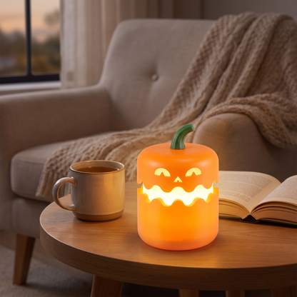 Foldable pumpkin LED night light glowing on a living room side table