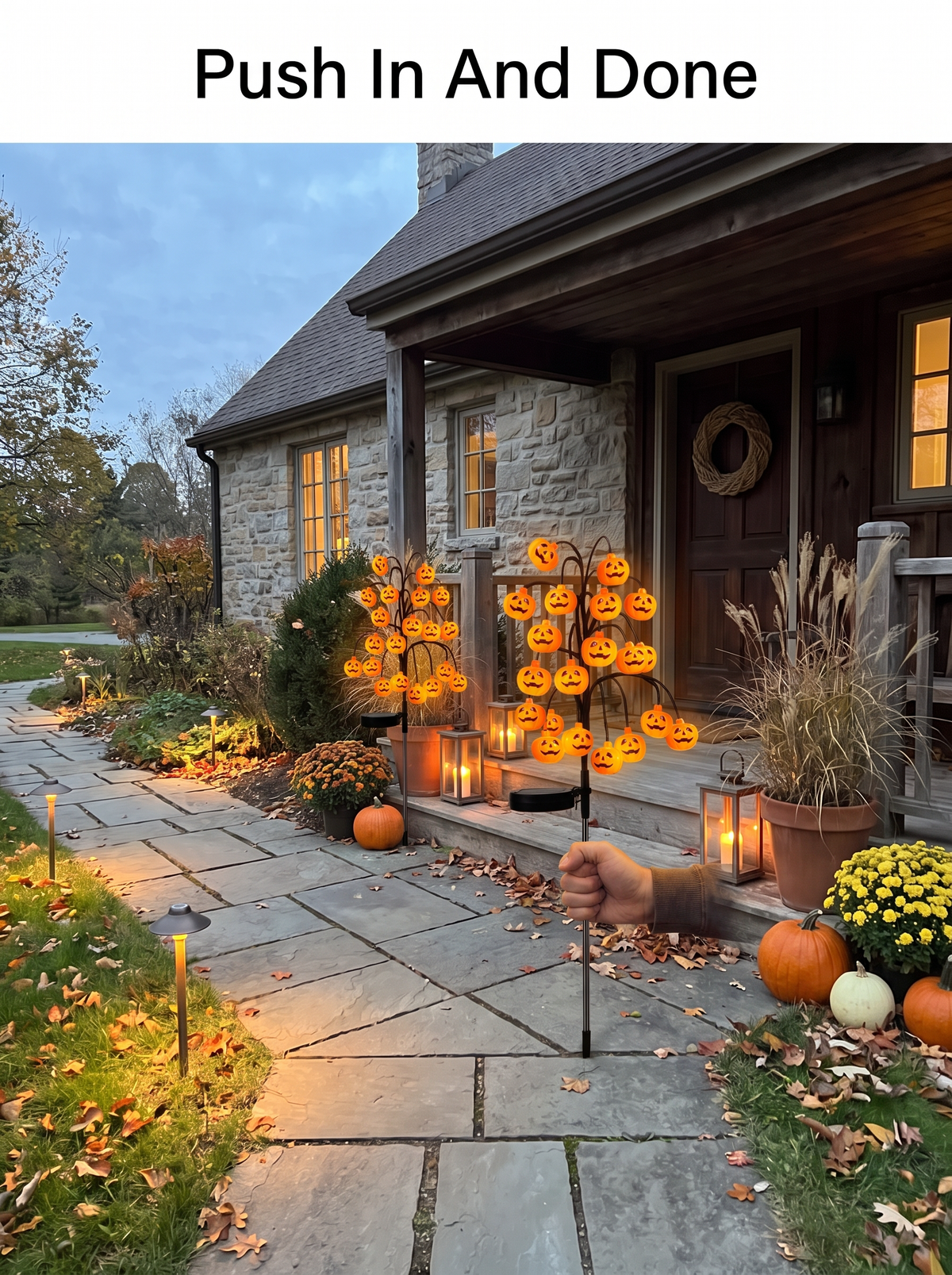 Pushing a solar pumpkin stake light into a lawn