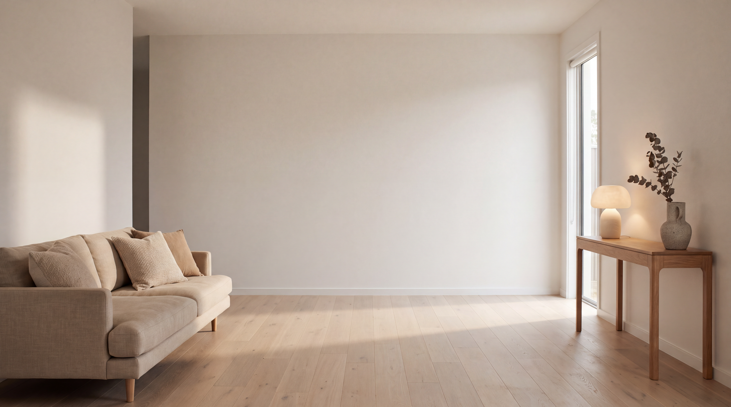 Calm open-plan living room in warm afternoon light with a glowing ceramic lamp